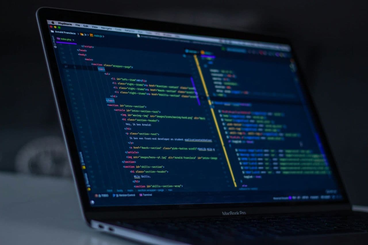 Bildschirm mit geöffnetem Quelltext und Browser-Entwicklertools einer Website, daneben handschriftliche Notizen zu Ladezeit und Seitenstruktur